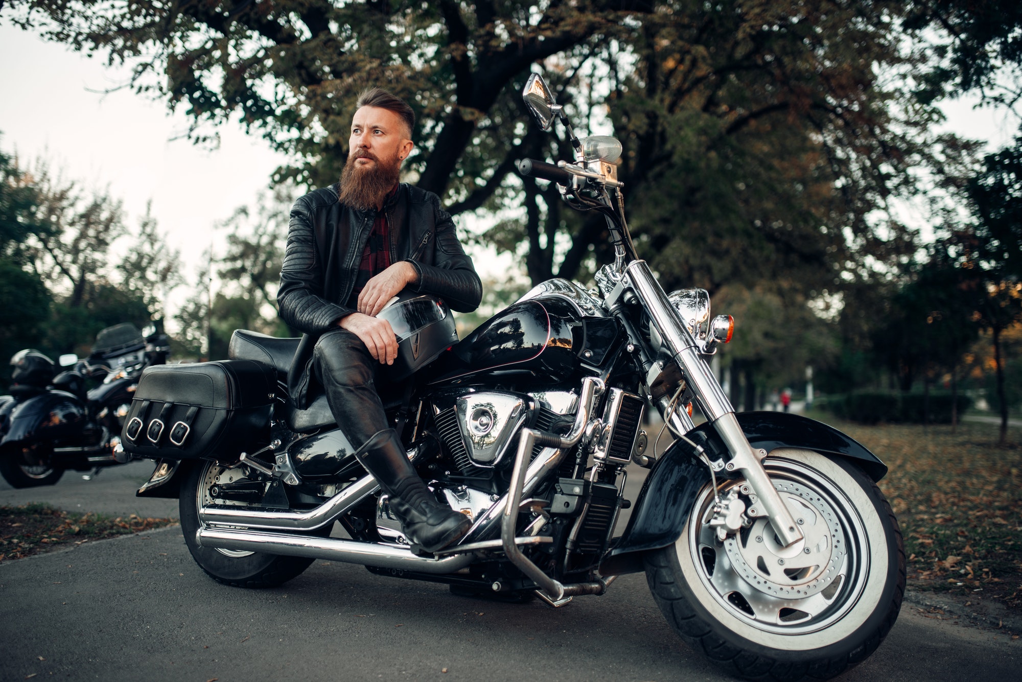 baerded-biker-poses-on-chopper-leaning-on-a-helmet.jpg